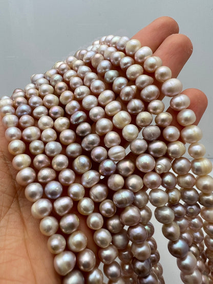 Freshwater Pearl, Natural Round Oval Creamish- Purple Pearl, strand length 15" size 7x8mm