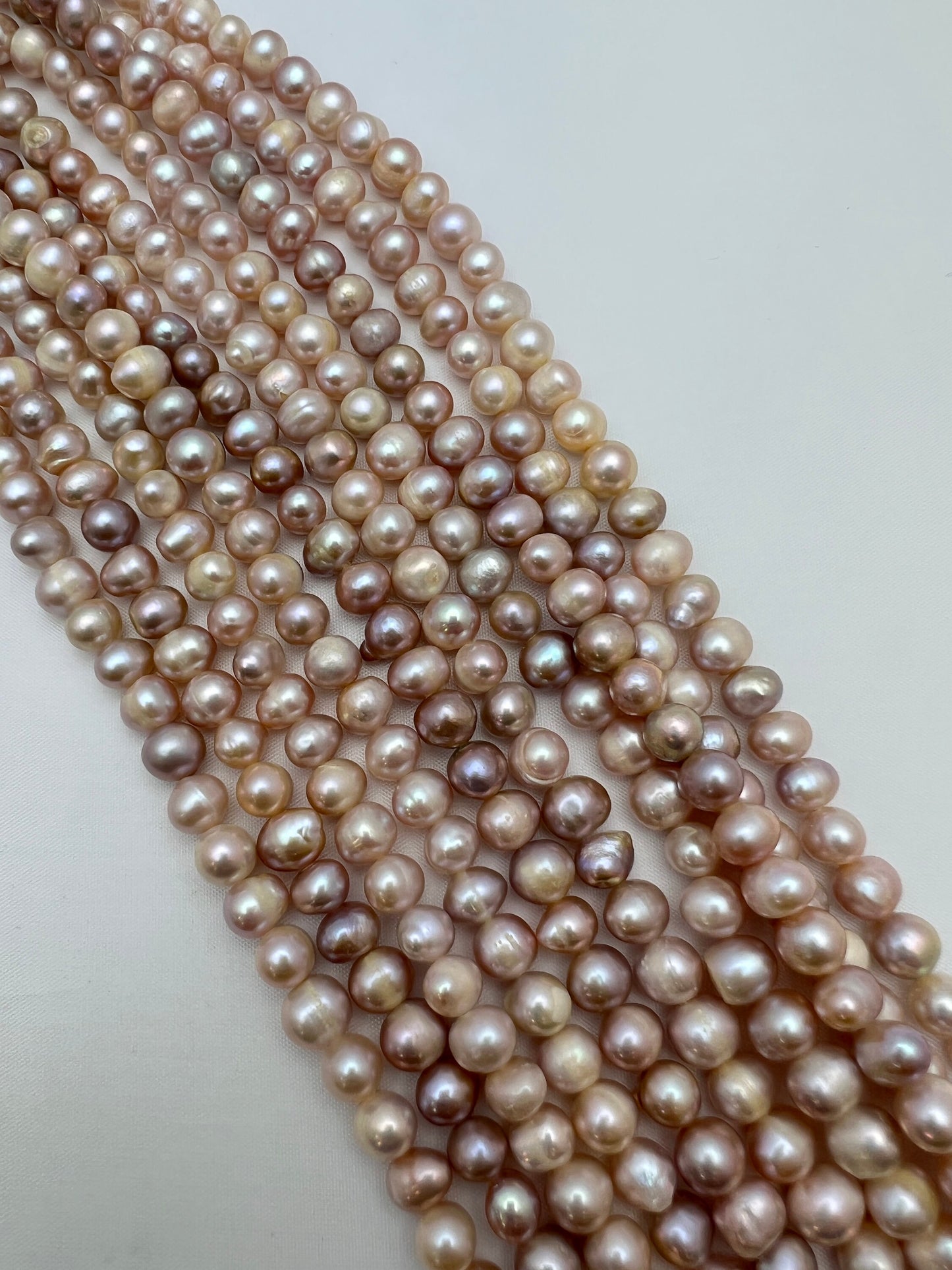 Freshwater Pearl, Natural Round Oval Creamish- Purple Pearl, strand length 15" size 7x8mm