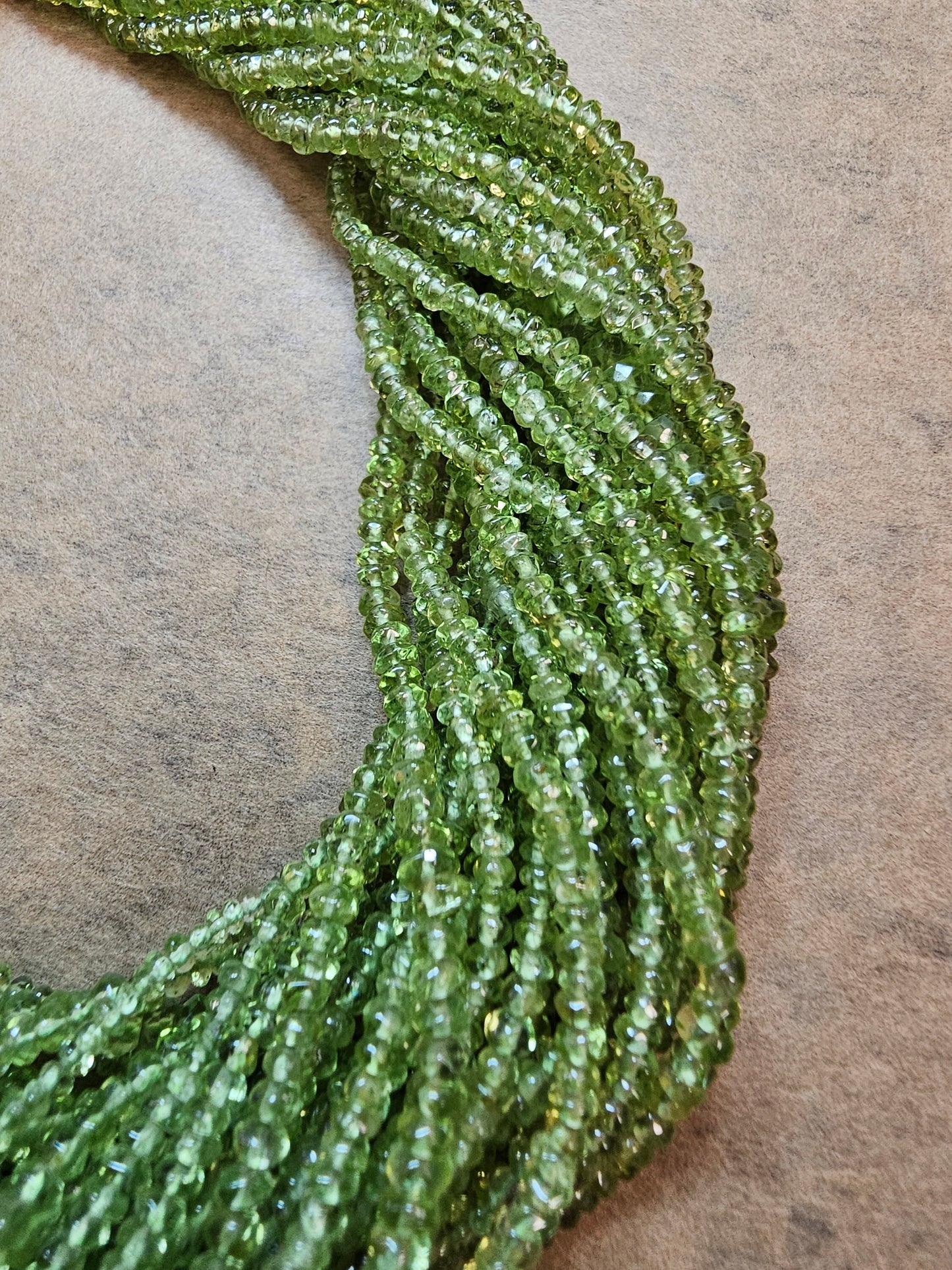 AA Peridot Gemstone Beads. Natural Rondelle Faceted Peridot Gemstone with strand length approx 14" Size 3-3.50, 3-4.50mm, 4-5mm